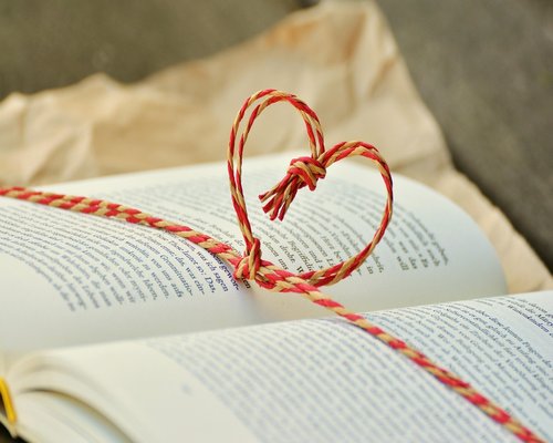 A relaxed person sitting in a quiet cafe setting with a book